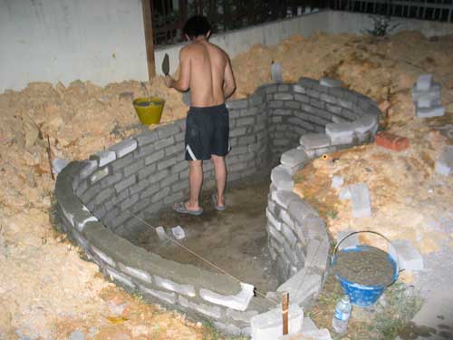 constructing the brick wall for koi pond wall