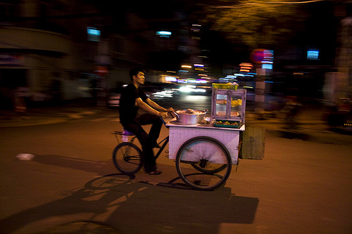 hawker paddling on the streets of ho chi minh city, vietnam