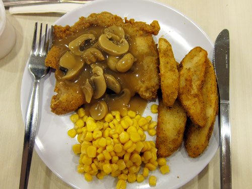 KFC chicken chop, with sweet corn, potato wedges, and mushroom sauce